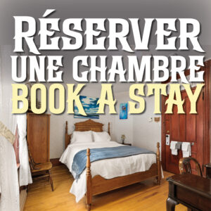 A perfectly made up bedroom filled with antique furnishings and fine linens at Le Griffon B&B in Shediac, NB.