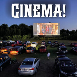 Dozens of cars with their lights still on await the start of the movies at the Neptune Drive-In Theatre in Shediac, NB.