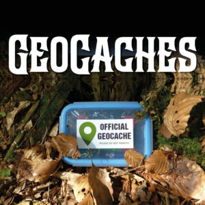 A picture of an "official geocache" hidden in a pile of leaves. The word "Geocaches" is displayed above.