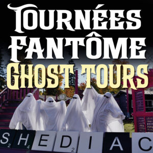 A group of four men are standing in front of the SHEDIAC Scrabble sign. They are wearing bedsheets and sunglasses and pretending to be ghosts.