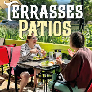 Two women sit and talk while eating salads and sandwiches at a metal table on Le Moque-Tortue's patio, in Shediac, NB.