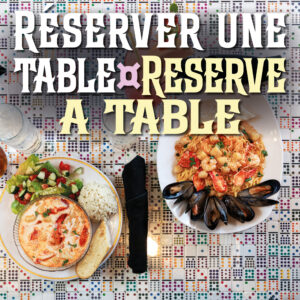 A seafood chowder and a seafood linguini next to each other on a table made entirely of dominos in Le Moque-Tortue's main dining room, in Shediac, NB.